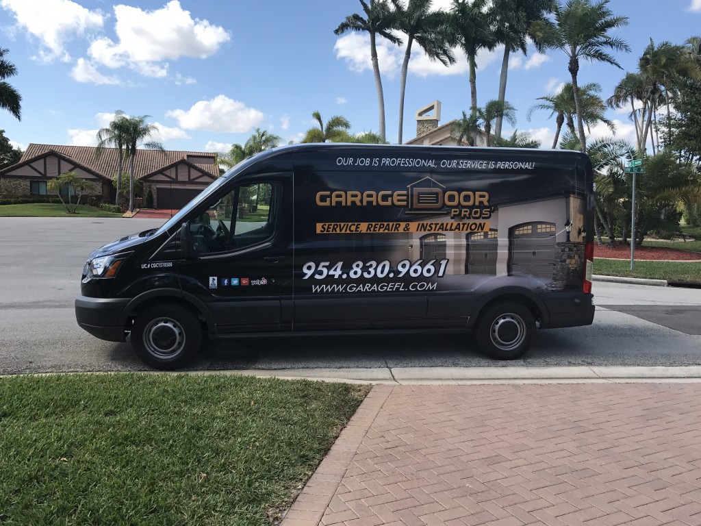 Garage Door Pros branded service van parked on a South Florida residential street
